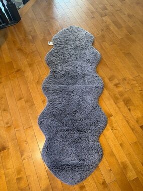 Plush gray sheepskin-style rug (70 inches long)